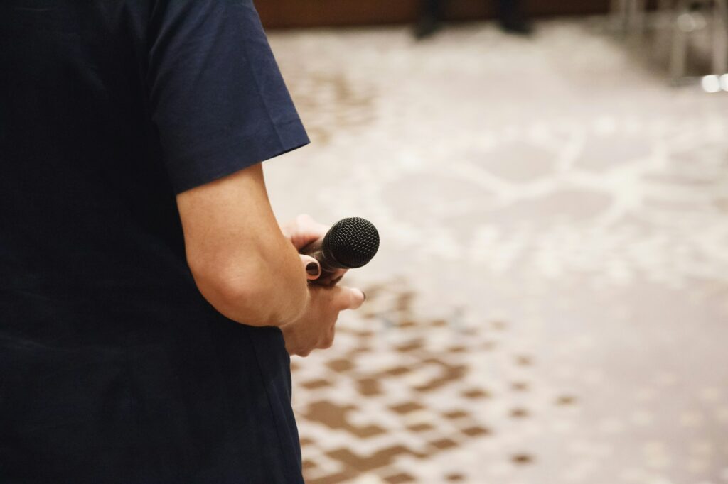Microphone in speaker's hands at conference